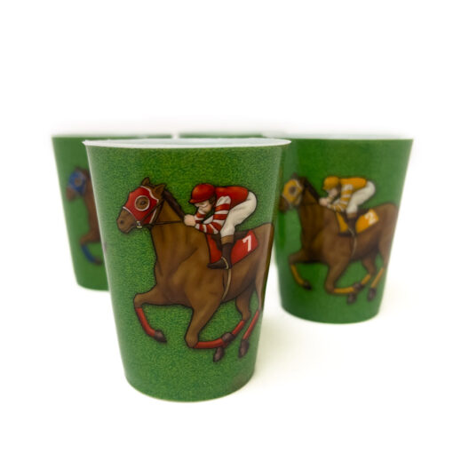 four green shot glasses with horse and jockey illustration .