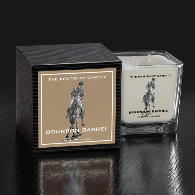 White Square Glass Candle in Bourbon Barrel Scent sitting next to Black packaging box. Sitting on black background.
