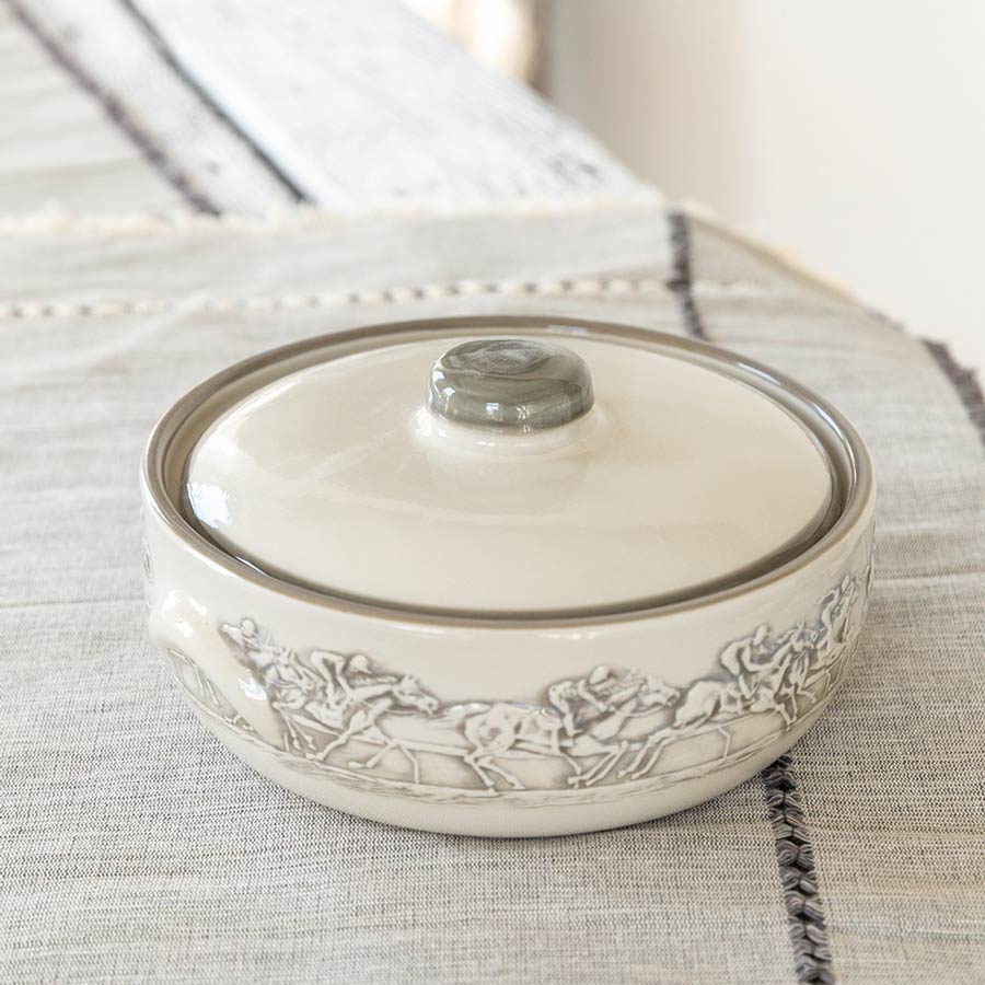 2 quart casserole dish with lid from Stoneware & Co in design Embossed Running Horse, on cloth table covering.