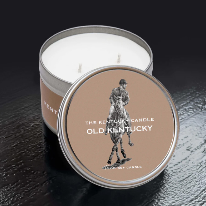 Round White Tin Candle in Old Kentucky Scent. Sitting on black background.