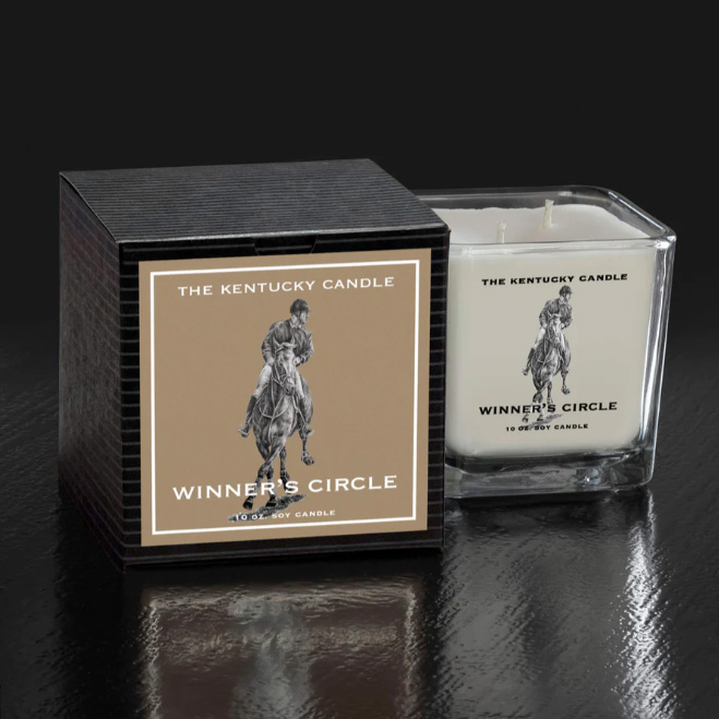 White Square Glass Candle in Winner's Circle Scent sitting next to Black packaging box. Sitting on black background.